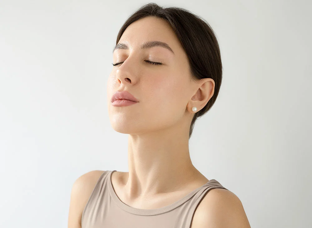 woman with her eyes closed | Top Miami Surgeon Gregory D. Lewen, MD