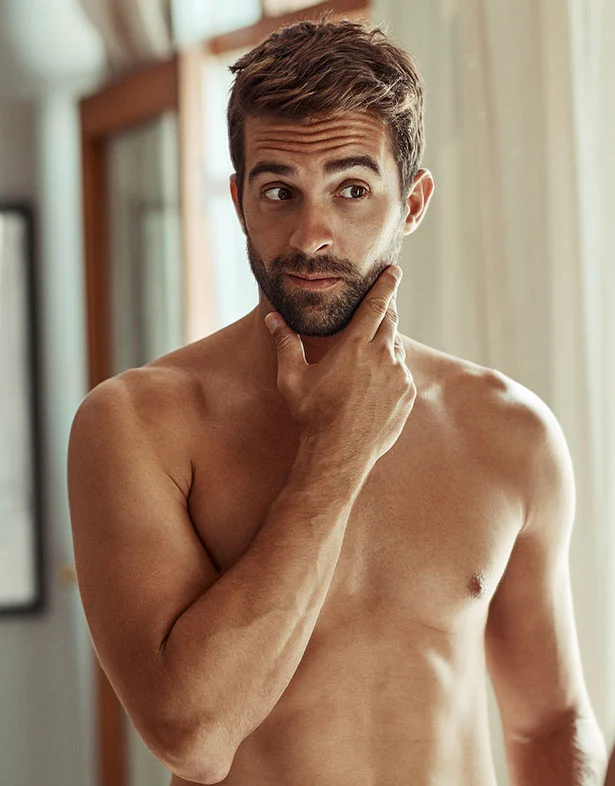 shirtless man rubbing chin | Top Miami Surgeon Gregory D. Lewen, MD